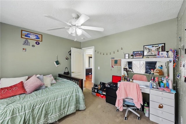 carpeted bedroom with a ceiling fan and a textured ceiling