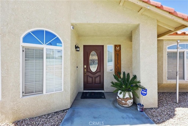 doorway to property with stucco siding