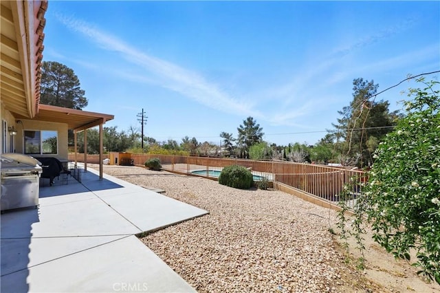 view of yard featuring a fenced backyard, a fenced in pool, and a patio area