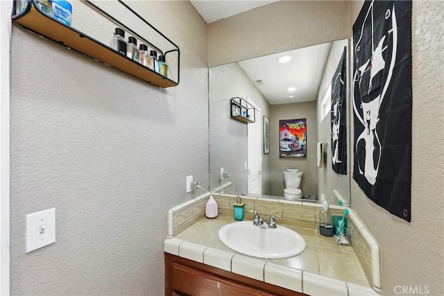 15710 Rimrock Rd, Apple Valley, CA 92307 - bathroom featuring vanity, recessed lighting, a textured wall, and toilet