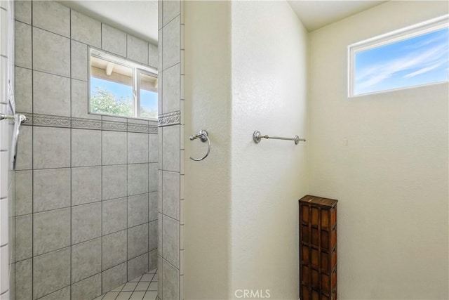 bathroom with tiled shower