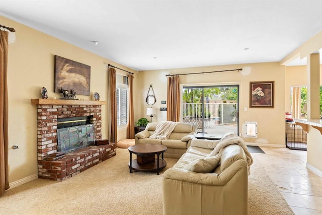 living area featuring a fireplace, a healthy amount of sunlight, and baseboards