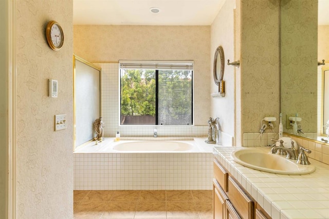 full bathroom with a bath, tile patterned flooring, and vanity