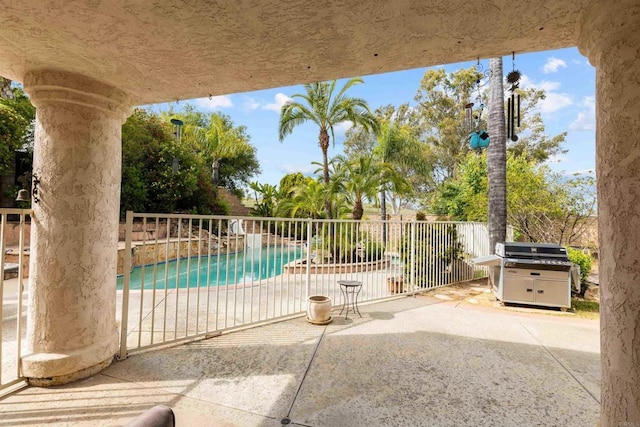 view of swimming pool with a patio, area for grilling, a fenced in pool, and fence