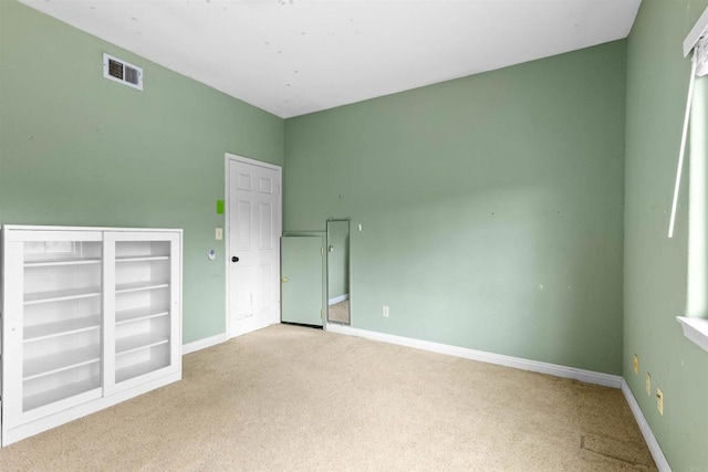 unfurnished bedroom featuring visible vents, carpet, and baseboards