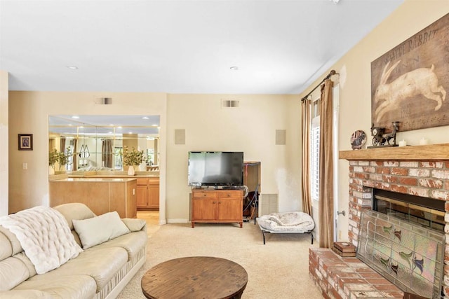 living area featuring a brick fireplace, visible vents, and light carpet