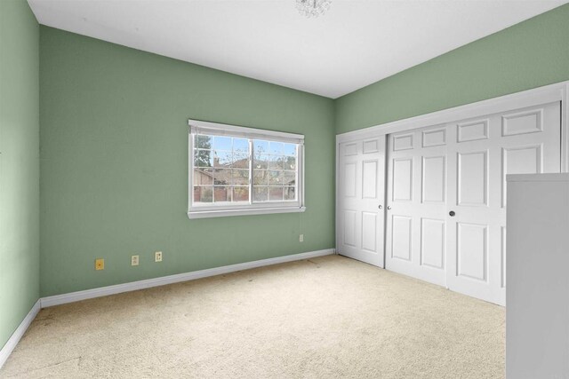 unfurnished bedroom featuring a closet, carpet flooring, and baseboards