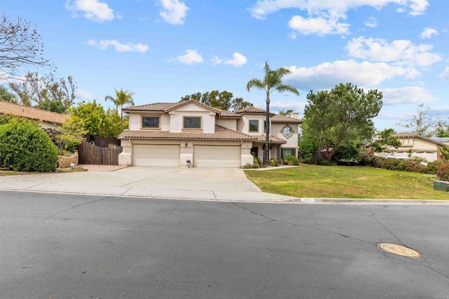 traditional-style home featuring fence, concrete driveway, a tile roof, an attached garage, and stucco siding