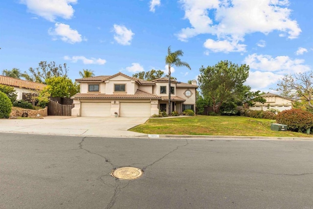 traditional home with a garage, a tile roof, stucco siding, and driveway