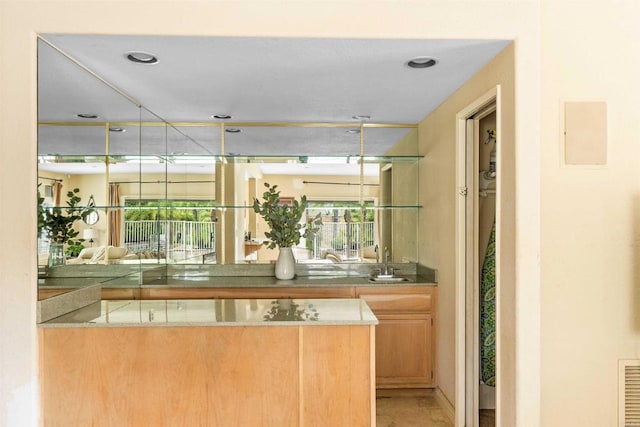 bar with plenty of natural light and a sink