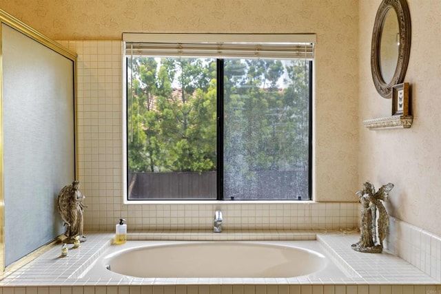 full bathroom with a garden tub, plenty of natural light, and wallpapered walls