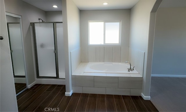 17995 Seaforth St, Hesperia, CA 92345 - full bathroom with wood finished floors, a stall shower, a bath, and recessed lighting