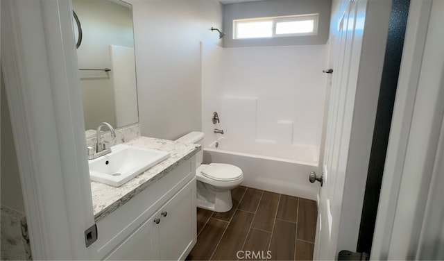 full bath with toilet, vanity, wood finished floors, and shower / bath combination