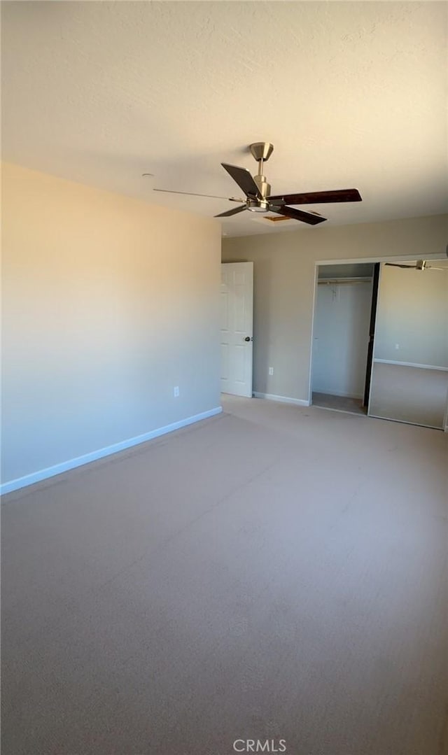 unfurnished bedroom featuring ceiling fan, a closet, and baseboards