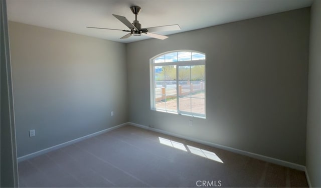 unfurnished room featuring baseboards and a ceiling fan