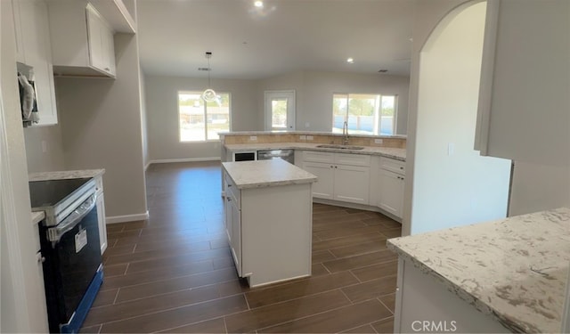 17995 Seaforth St, Hesperia, CA 92345 - kitchen with appliances with stainless steel finishes, wood finish floors, healthy amount of natural light, light stone counters, and recessed lighting