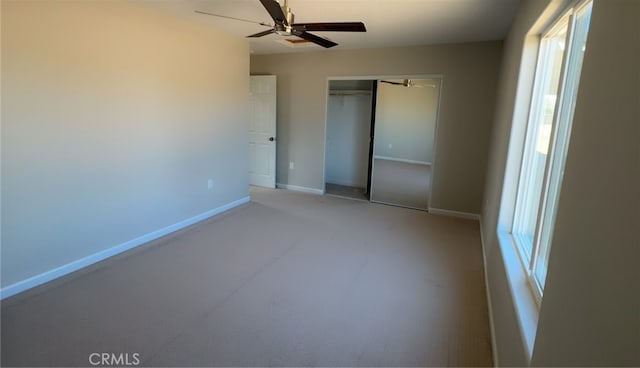 unfurnished bedroom with ceiling fan, baseboards, and a closet