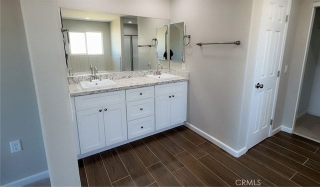 17995 Seaforth St, Hesperia, CA 92345 - bathroom featuring double vanity, wood finished floors, and an enclosed shower