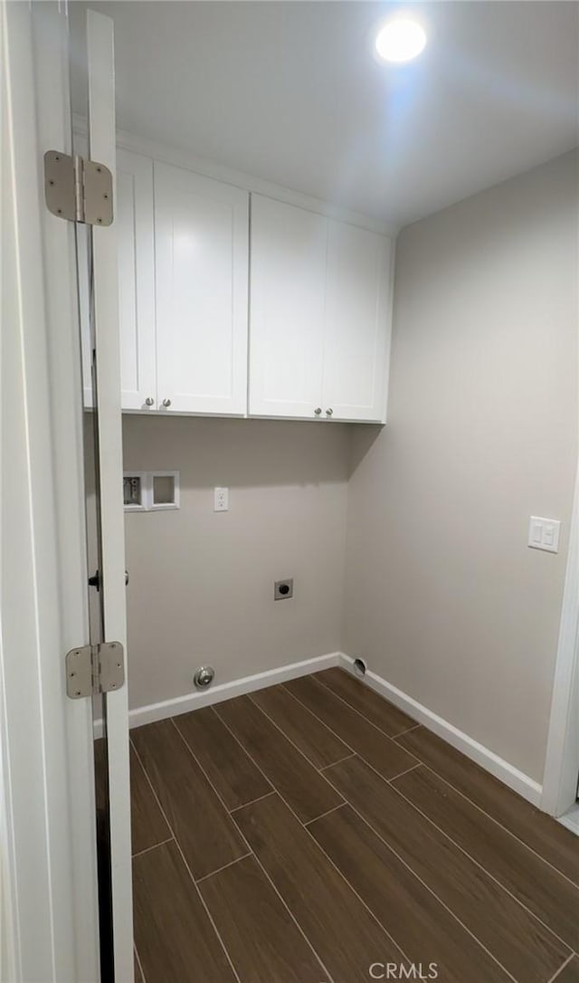 washroom featuring hookup for an electric dryer, cabinet space, washer hookup, baseboards, and wood finish floors