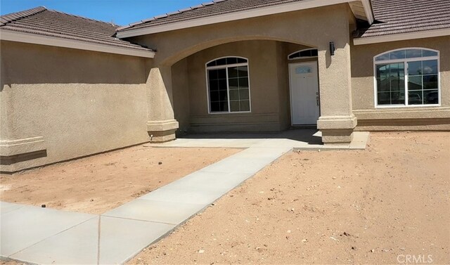 17995 Seaforth St, Hesperia, CA 92345 - view of exterior entry featuring stucco siding and a tiled roof
