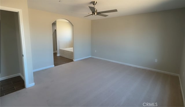 17995 Seaforth St, Hesperia, CA 92345 - empty room with arched walkways, ceiling fan, and carpet flooring