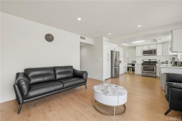 1555 Berkshire Dr, Palmdale, CA 93551 - living room featuring visible vents, recessed lighting, light wood-style flooring, and baseboards