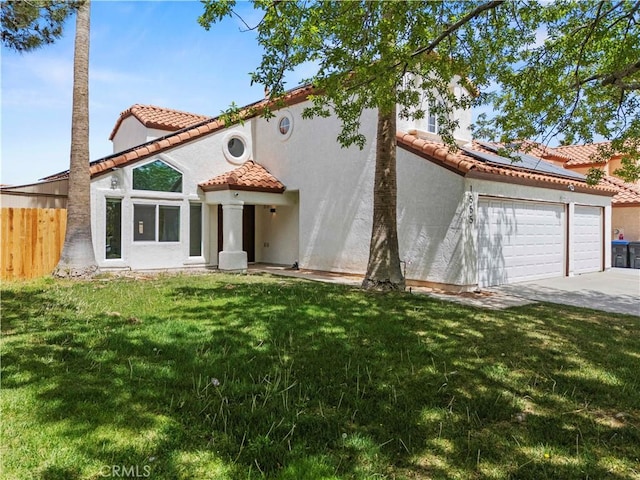 mediterranean / spanish house with a tile roof, a garage, fence, roof mounted solar panels, and concrete driveway