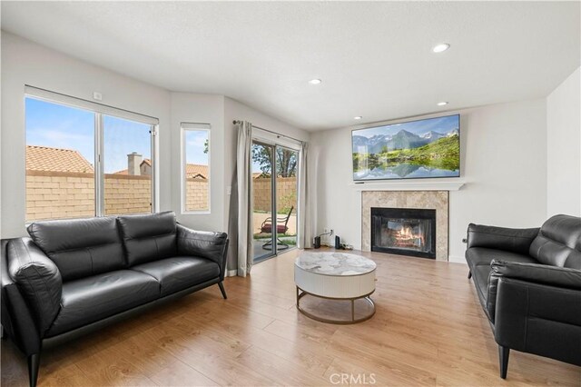 1555 Berkshire Dr, Palmdale, CA 93551 - living area featuring a fireplace, recessed lighting, and light wood-style flooring