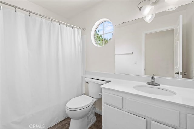full bath with vanity, toilet, and curtained shower