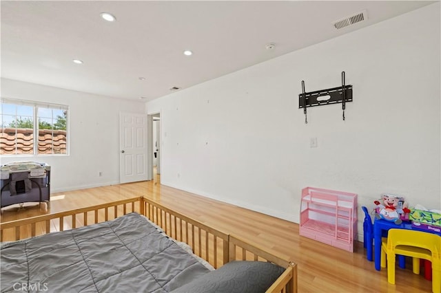 bedroom featuring recessed lighting, baseboards, visible vents, and wood finished floors