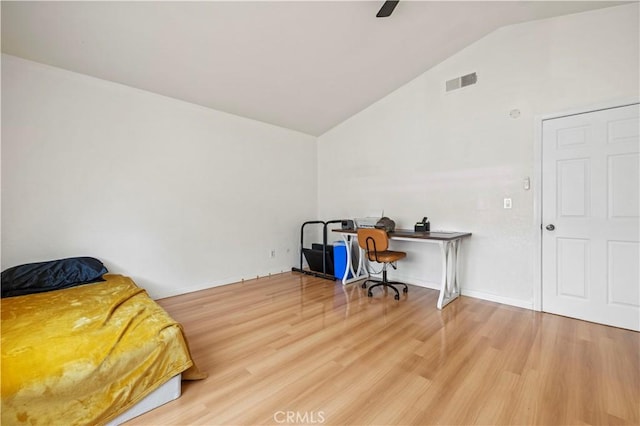 bedroom with visible vents, baseboards, lofted ceiling, and light wood-type flooring