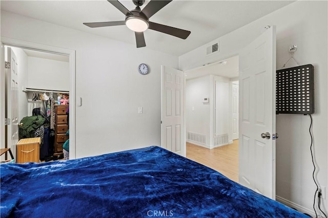 unfurnished bedroom with ceiling fan, visible vents, and wood finished floors