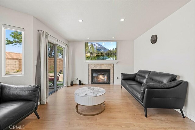 1555 Berkshire Dr, Palmdale, CA 93551 - living area featuring recessed lighting, a glass covered fireplace, and light wood finished floors