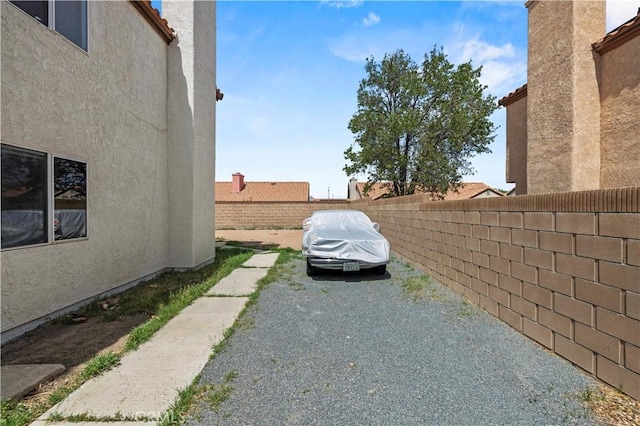 view of property exterior with fence private yard and stucco siding