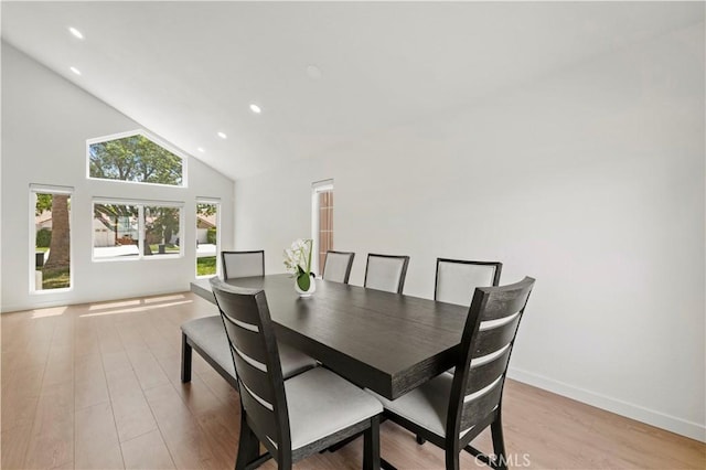 dining area featuring light wood-style floors, high vaulted ceiling, baseboards, and recessed lighting