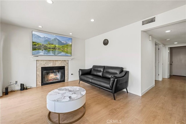 living area featuring visible vents, recessed lighting, wood finished floors, and a fireplace