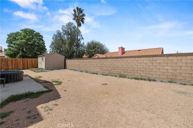 view of yard featuring an outdoor structure, a patio, a fenced backyard, and a storage unit