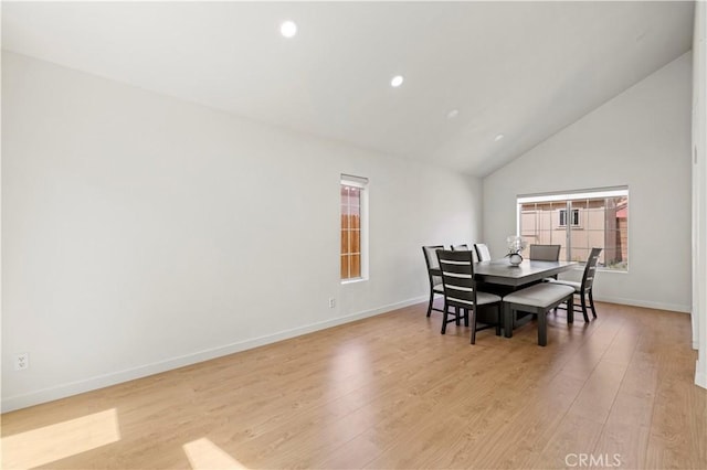 dining space featuring recessed lighting, baseboards, high vaulted ceiling, and light wood-type flooring