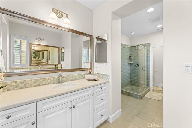 bathroom with vanity, a stall shower, tile patterned flooring, and a healthy amount of sunlight