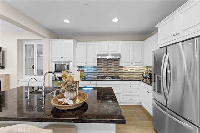 129 Pathway, Irvine, CA 92618 - kitchen featuring stainless steel appliances, white cabinetry, backsplash, recessed lighting, and light wood finished floors