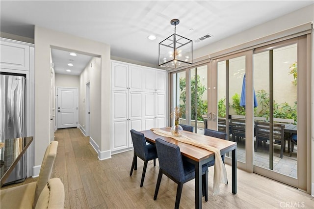 dining space featuring visible vents, recessed lighting, light wood finished floors, and a notable chandelier