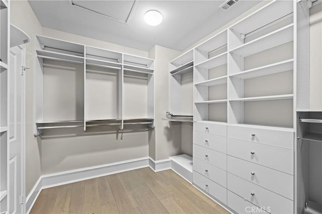 walk in closet featuring wood finished floors and visible vents