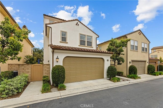 129 Pathway, Irvine, CA 92618 - mediterranean / spanish-style house with a tiled roof, stucco siding, a garage, and concrete driveway
