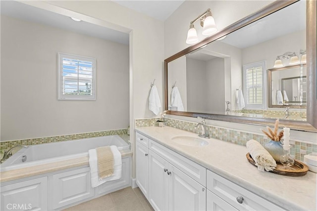 bathroom with vanity, backsplash, tile patterned floors, and a bath