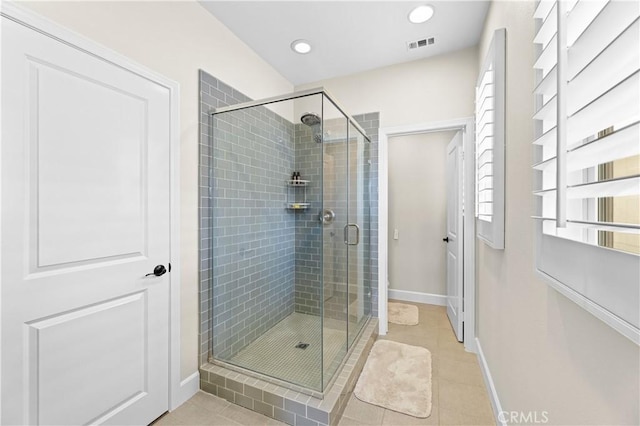 full bath with baseboards, tile patterned floors, visible vents, and a shower stall