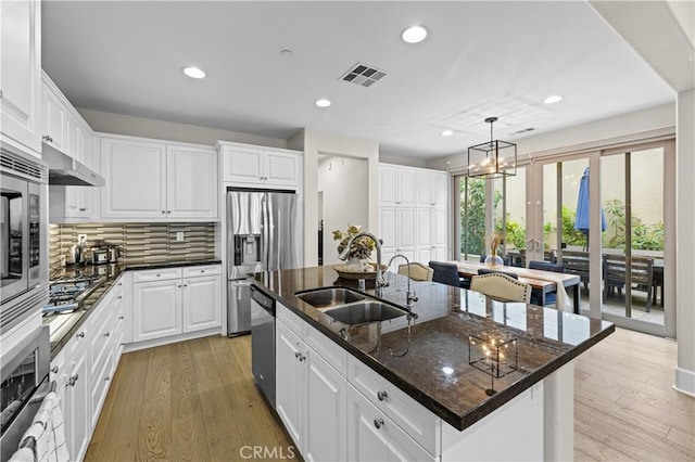 129 Pathway, Irvine, CA 92618 - kitchen featuring a sink, stainless steel appliances, a kitchen island with sink, recessed lighting, and light wood finished floors