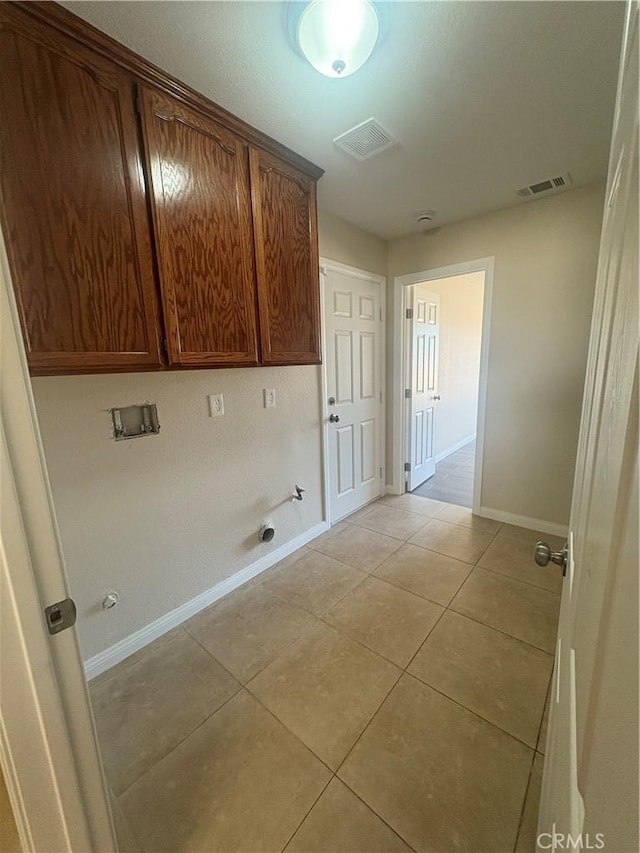 washroom with gas dryer hookup, washer hookup, cabinet space, and visible vents
