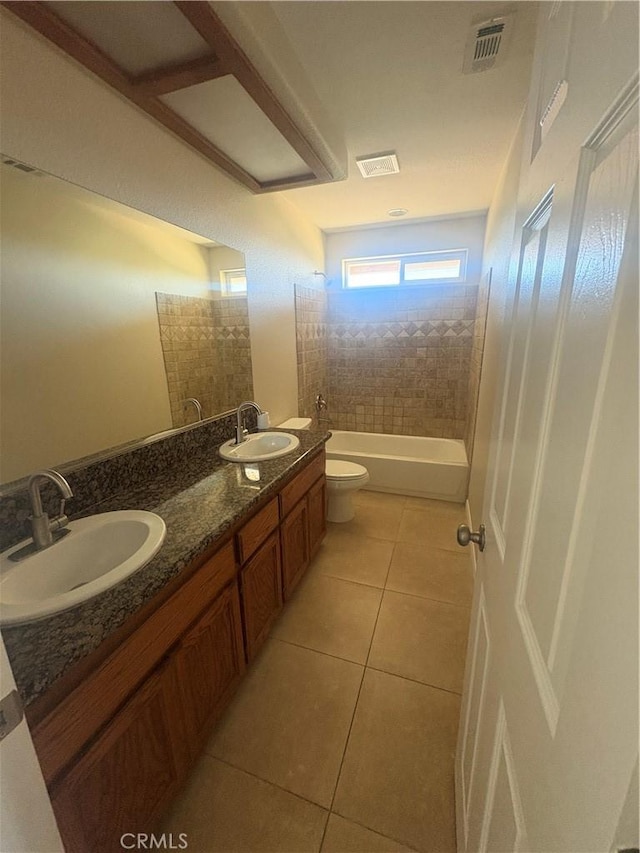 bathroom featuring toilet, visible vents, a sink, and tile patterned flooring