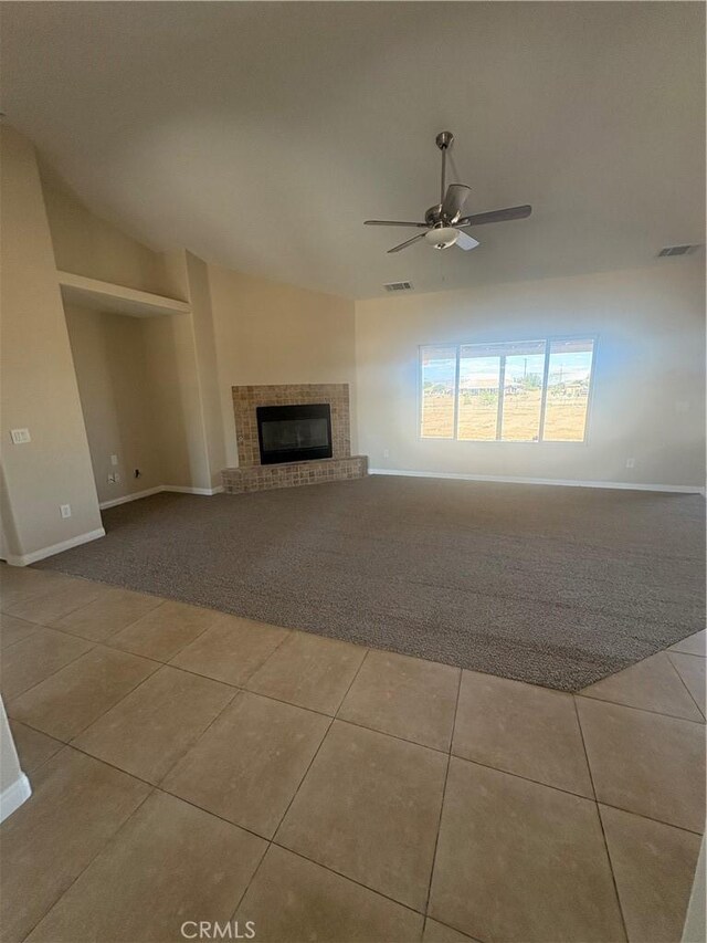 unfurnished living room featuring tile patterned floors, baseboards, and lofted ceiling