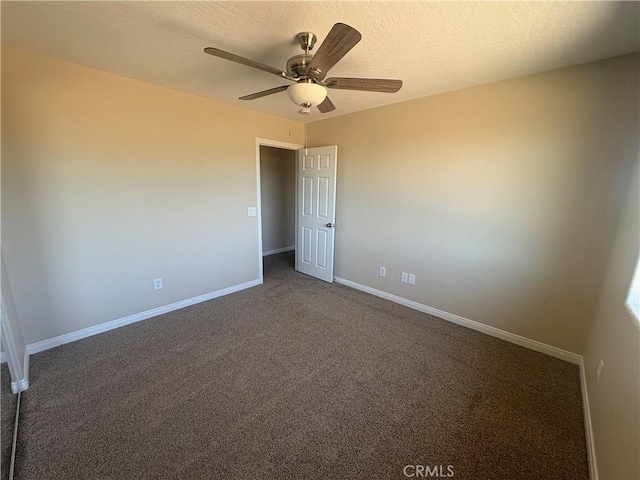 empty room featuring baseboards, ceiling fan, and carpet flooring